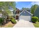 Charming two-story home with blue siding, brick accents, and a well-manicured front yard at 515 Quinn Dr, Woodstock, GA 30188