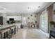 Bright kitchen featuring granite countertops, a breakfast bar, and a view to the backyard through sliding glass doors at 515 Quinn Dr, Woodstock, GA 30188