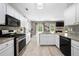 Modern kitchen featuring stainless steel appliances, granite countertops, and stylish backsplash at 515 Quinn Dr, Woodstock, GA 30188