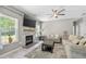 Cozy living room with a fireplace, large windows, and a comfortable seating area at 515 Quinn Dr, Woodstock, GA 30188