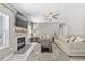 Inviting living room featuring a stone fireplace, mantle, large TV and a comfortable seating arrangement at 515 Quinn Dr, Woodstock, GA 30188