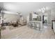 Open-concept living area with wood floors, neutral tones, modern lighting, and a view to the kitchen at 515 Quinn Dr, Woodstock, GA 30188