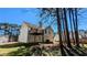 Exterior view of the house showcasing a deck, trees, and lawn at 831 Stonebrook Dr, Lithonia, GA 30058