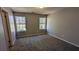 Bedroom featuring two windows, neutral walls, and carpet flooring at 831 Stonebrook Dr, Lithonia, GA 30058