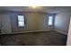 Large carpeted bedroom with neutral walls, a door to the outside, and natural light at 831 Stonebrook Dr, Lithonia, GA 30058