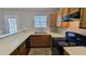 Traditional kitchen with oak cabinets, black appliances, and a window view at 831 Stonebrook Dr, Lithonia, GA 30058