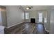 Cozy living room featuring wood floors, a fireplace, and a door that leads to the back yard at 831 Stonebrook Dr, Lithonia, GA 30058