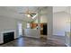 Open living space with wood floors, featuring a fireplace, adjacent kitchen, and high ceilings at 831 Stonebrook Dr, Lithonia, GA 30058