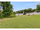 View of the back of the house with a large, grassy lawn at 1083 Amelia Sw Dr, Marietta, GA 30060