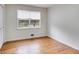 Bright bedroom with hardwood flooring, neutral paint, and a large window at 1083 Amelia Sw Dr, Marietta, GA 30060