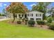Charming home featuring a brick facade, a well-manicured lawn, and a convenient carport at 1083 Amelia Sw Dr, Marietta, GA 30060