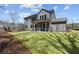 Well-manicured backyard featuring a charming two-story home with gray siding and a covered patio at 1975 Sage Lake Bend Sw, Marietta, GA 30064
