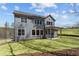 Exterior features of a gray home with a covered patio and well-maintained backyard lawn at 1975 Sage Lake Bend Sw, Marietta, GA 30064