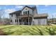 Beautiful gray home with a pristine lawn and covered patio creates a serene outdoor space at 1975 Sage Lake Bend Sw, Marietta, GA 30064