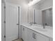 Bright bathroom featuring a double vanity with modern fixtures and white cabinetry at 1975 Sage Lake Bend Sw, Marietta, GA 30064