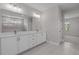 Modern bathroom with double vanity, framed mirror, and white cabinets with contemporary fixtures at 1975 Sage Lake Bend Sw, Marietta, GA 30064