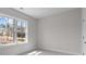 Neutral bedroom with carpet, window overlooking the backyard, and a white door at 1975 Sage Lake Bend Sw, Marietta, GA 30064