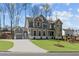 Beautiful two-story home featuring gray siding, white trim, and a well-manicured lawn at 1975 Sage Lake Bend Sw, Marietta, GA 30064