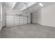 Spacious two car garage with concrete flooring and white walls at 1975 Sage Lake Bend Sw, Marietta, GA 30064