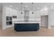 Open kitchen with white cabinets, stainless steel appliances, and a navy blue center island at 1975 Sage Lake Bend Sw, Marietta, GA 30064