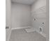 Functional laundry room with tiled floor, utility sink, and convenient washer and dryer hookups at 1975 Sage Lake Bend Sw, Marietta, GA 30064