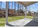 View of the backyard from a covered patio with concrete flooring and lush green grass at 1975 Sage Lake Bend Sw, Marietta, GA 30064