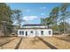 This house features a spacious backyard with a newly constructed modern addition at 7180 Whitfield Dr, Riverdale, GA 30296