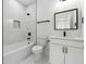 This bathroom features a tub, a modern vanity, and elegant tiling at 7180 Whitfield Dr, Riverdale, GA 30296