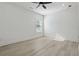 Bright bedroom features neutral paint, a ceiling fan, and a large window for natural light at 7180 Whitfield Dr, Riverdale, GA 30296