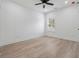 This bedroom has wood-look floors, a ceiling fan, and a bright window at 7180 Whitfield Dr, Riverdale, GA 30296