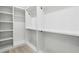 Spacious walk-in closet with white shelving and wooden floors at 7180 Whitfield Dr, Riverdale, GA 30296