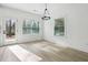 Cozy dining area with modern light fixture, lots of natural light, and access to the outdoors at 7180 Whitfield Dr, Riverdale, GA 30296