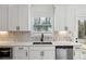 Kitchen featuring stainless steel appliances, quartz countertops, and breakfast bar at 7180 Whitfield Dr, Riverdale, GA 30296