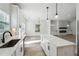 Kitchen featuring stainless steel appliances, quartz countertops, island and open floorplan at 7180 Whitfield Dr, Riverdale, GA 30296