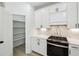 Kitchen featuring stainless steel oven, white cabinets, tiled backsplash and walk-in pantry at 7180 Whitfield Dr, Riverdale, GA 30296