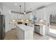 Modern white kitchen with stainless steel appliances, an island, and ample cabinet space at 7180 Whitfield Dr, Riverdale, GA 30296