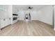 Bright living space with hardwood floors, a modern fireplace, and views into the foyer at 7180 Whitfield Dr, Riverdale, GA 30296