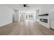 Spacious living room featuring modern electric fireplace, hardwood floors, and open-concept layout at 7180 Whitfield Dr, Riverdale, GA 30296