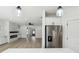 Open floorplan from kitchen to living room with modern fireplace and stainless steel appliances at 7180 Whitfield Dr, Riverdale, GA 30296