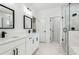 Bathroom featuring dual sinks, quartz counters, and tiled walk-in shower at 7180 Whitfield Dr, Riverdale, GA 30296