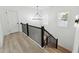 Modern staircase with black railings, wood stairs, and natural light at 7180 Whitfield Dr, Riverdale, GA 30296