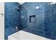 Stylish bathroom featuring blue tiled shower with a niche and a modern shower head at 2300 Newport Lndg, Alpharetta, GA 30009