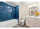 Modern bathroom featuring blue tiled shower and tub with new fixtures, complemented by a contemporary vanity and flooring at 2300 Newport Lndg, Alpharetta, GA 30009