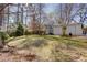 Spacious backyard featuring a well-maintained lawn, mature trees, a privacy fence, and a shed at 247 Heaton Park Dr, Atlanta, GA 30030