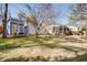 Expansive backyard showcasing the main house, a screened-in porch, and a separate building with a modern glass door at 247 Heaton Park Dr, Atlanta, GA 30030