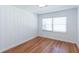 Bright, empty bedroom with hardwood floors, white walls, and window with blinds at 247 Heaton Park Dr, Atlanta, GA 30030