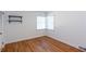 Bedroom featuring hardwood floors, white walls, and two black shelves at 247 Heaton Park Dr, Atlanta, GA 30030