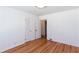 Empty bedroom with hardwood floors, white walls, interior door and closet at 247 Heaton Park Dr, Atlanta, GA 30030