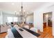 Open-concept view of the dining and living room areas with hardwood floors and stylish light fixture at 247 Heaton Park Dr, Atlanta, GA 30030