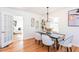 Elegant dining room with hardwood floors, modern light fixture, and a view into the living room at 247 Heaton Park Dr, Atlanta, GA 30030